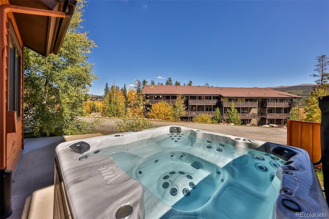 view of swimming pool featuring a hot tub