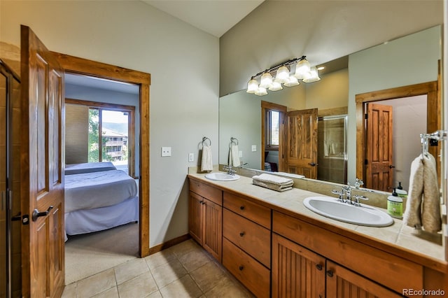 bathroom with vanity, tile patterned flooring, and an enclosed shower