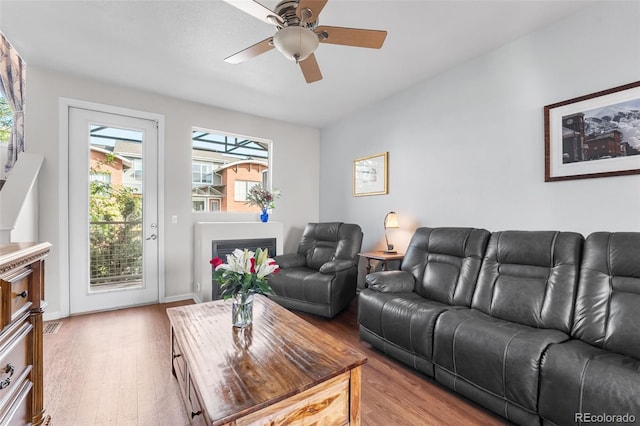 living room with a ceiling fan and wood finished floors