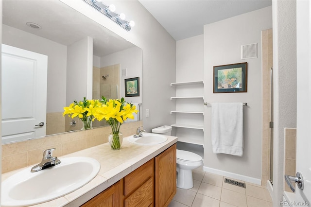 bathroom featuring a sink, tile patterned floors, and visible vents