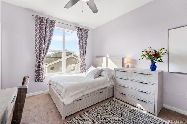 carpeted bedroom with baseboards and a ceiling fan