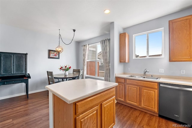 kitchen featuring stainless steel dishwasher, light countertops, a sink, and dark wood-type flooring
