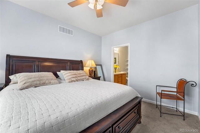 bedroom with visible vents, light carpet, baseboards, a ceiling fan, and ensuite bath