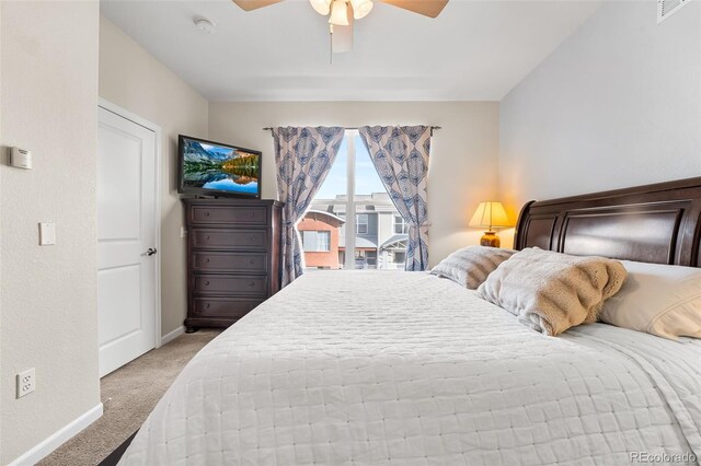 carpeted bedroom featuring visible vents, a ceiling fan, and baseboards