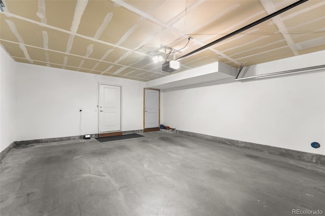 garage with baseboards and a garage door opener