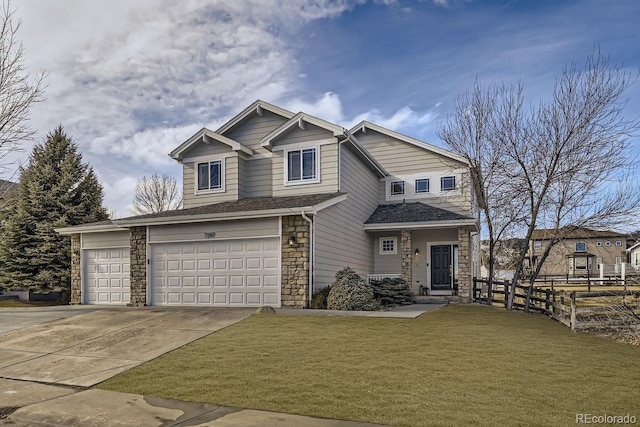 view of front of house with concrete driveway, a front yard, fence, a garage, and stone siding