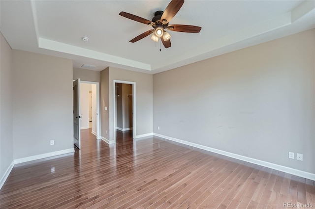 23993 E Briarwood Dr, Aurora, CO 80016 - empty room featuring a tray ceiling, a ceiling fan, and wood finished floors