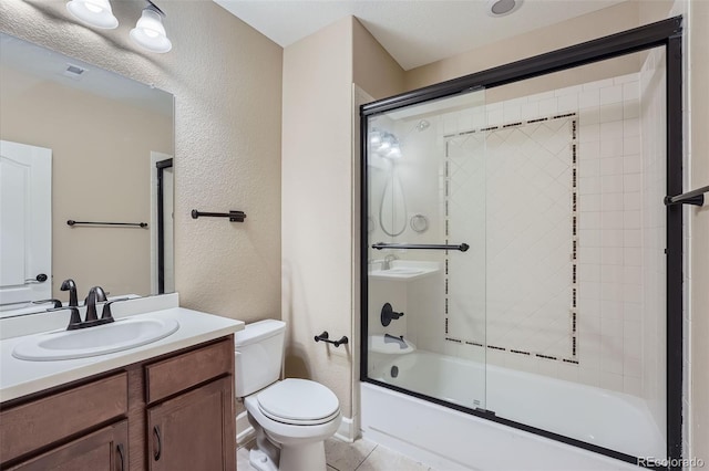 23993 E Briarwood Dr, Aurora, CO 80016 - bathroom with bath / shower combo with glass door, a textured wall, vanity, and tile patterned floors