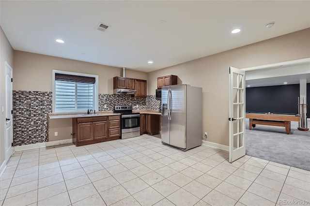 23993 E Briarwood Dr, Aurora, CO 80016 - kitchen featuring stainless steel appliances, light countertops, light tile patterned floors, under cabinet range hood, and billiards table