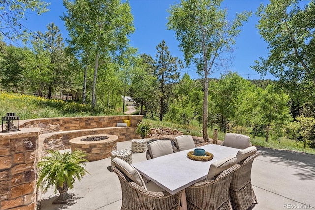 view of patio / terrace with an outdoor fire pit