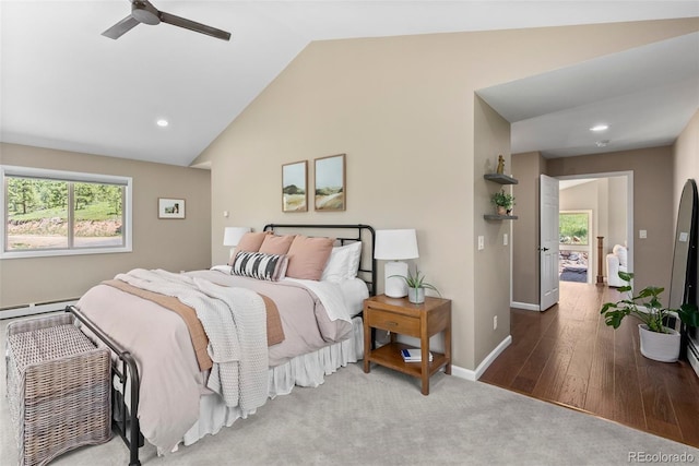 bedroom with ceiling fan, wood-type flooring, a baseboard heating unit, and lofted ceiling