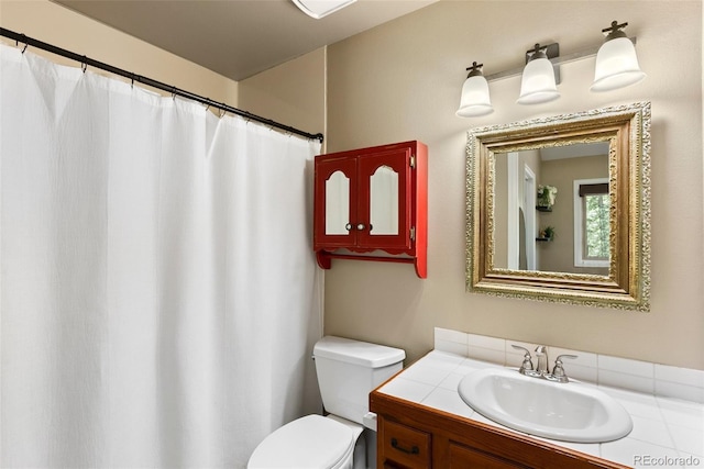 bathroom with toilet and vanity