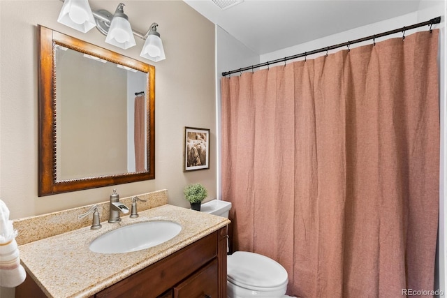 bathroom featuring toilet and vanity