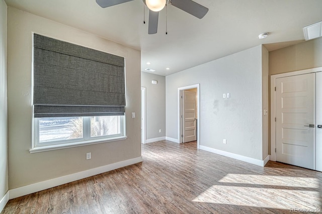 unfurnished room with hardwood / wood-style flooring and ceiling fan