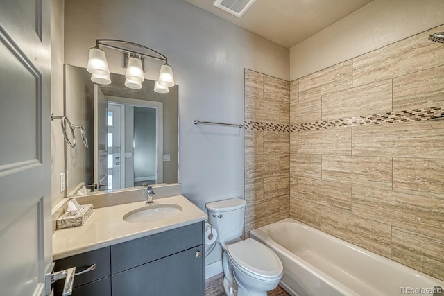 full bathroom with vanity, toilet, and tiled shower / bath