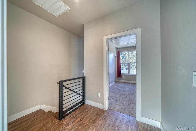 hallway with hardwood / wood-style flooring