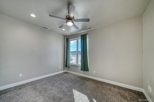 unfurnished room with ceiling fan and carpet