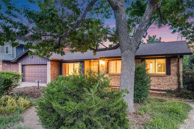 7382 E Bates Dr, Denver, CO 80231 - view of front of house with brick siding, an attached garage, concrete driveway, and roof with shingles