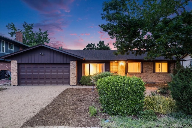 7382 E Bates Dr, Denver, CO 80231 - view of front of property featuring brick siding, an attached garage, and concrete driveway