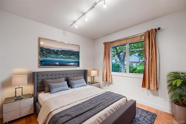7382 E Bates Dr, Denver, CO 80231 - bedroom with wood finished floors and rail lighting