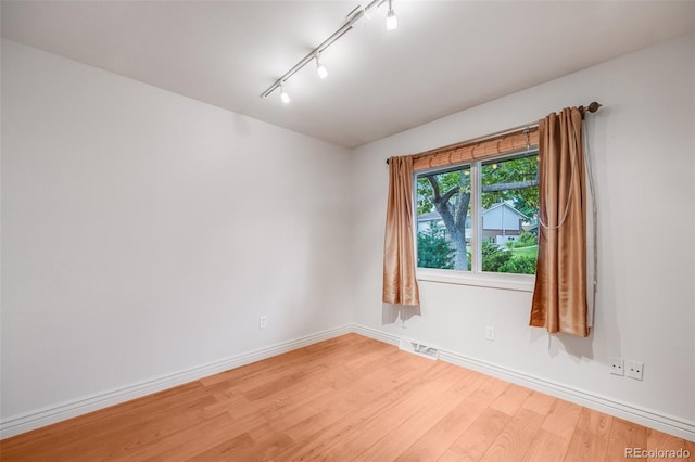 7382 E Bates Dr, Denver, CO 80231 - spare room featuring light wood finished floors and rail lighting