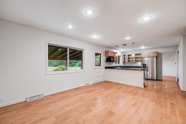 7382 E Bates Dr, Denver, CO 80231 - kitchen with stainless steel fridge, black microwave, a peninsula, dark countertops, and light wood finished floors