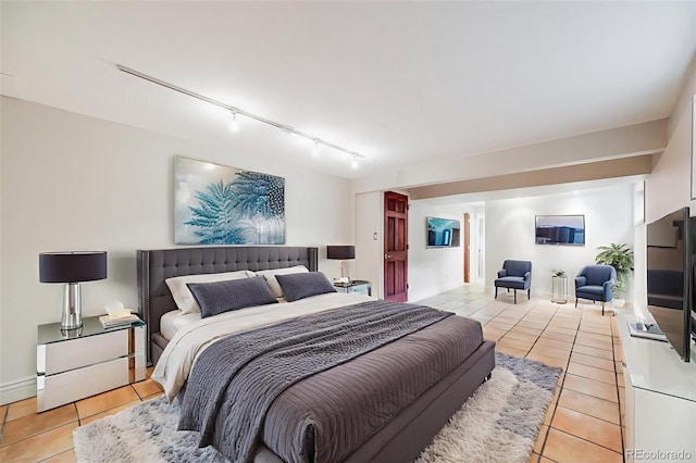 7382 E Bates Dr, Denver, CO 80231 - bedroom with track lighting and light tile patterned flooring