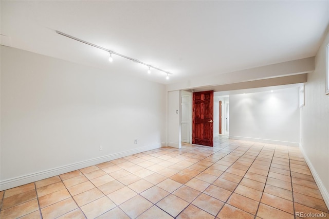 7382 E Bates Dr, Denver, CO 80231 - empty room with light tile patterned floors and rail lighting
