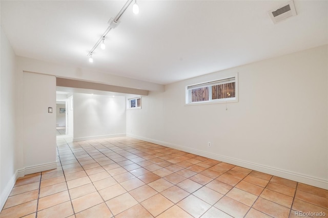 7382 E Bates Dr, Denver, CO 80231 - below grade area with light tile patterned flooring and track lighting