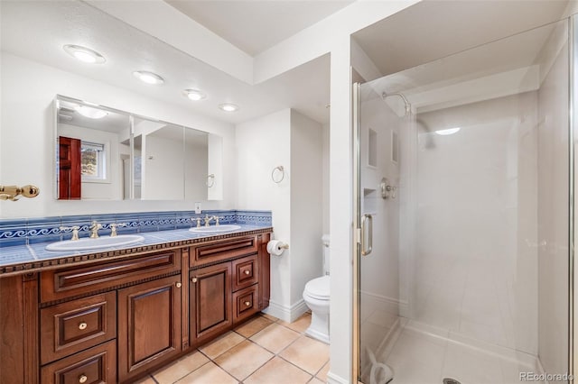 7382 E Bates Dr, Denver, CO 80231 - full bath with a stall shower, double vanity, and tile patterned floors
