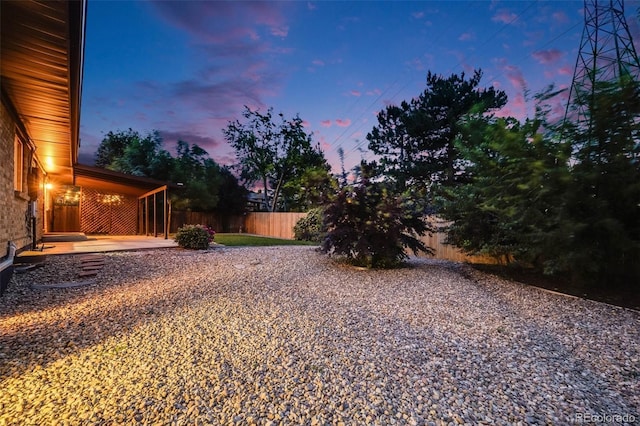 7382 E Bates Dr, Denver, CO 80231 - yard at dusk with a patio area