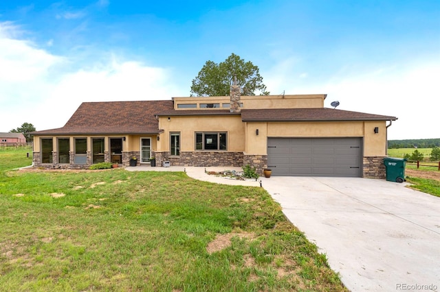 view of front of home with a garage and a front yard