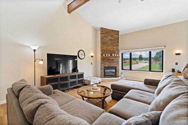 living room with beamed ceiling, high vaulted ceiling, light hardwood / wood-style flooring, and a fireplace