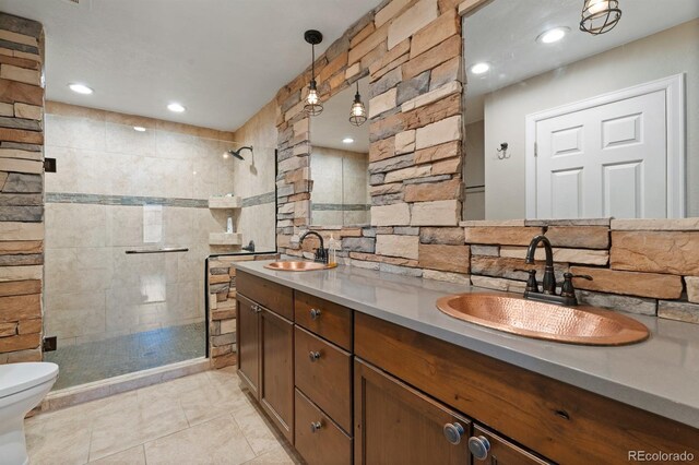 bathroom with tile patterned floors, toilet, walk in shower, and vanity