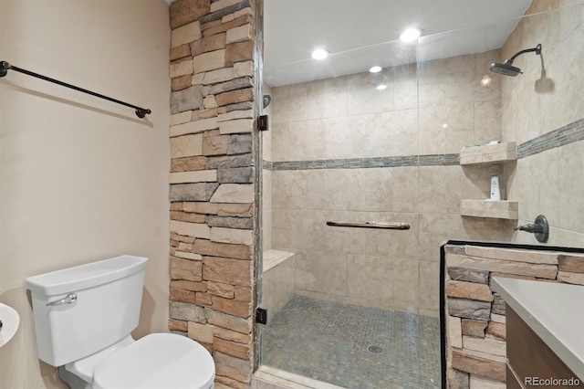 bathroom with toilet, vanity, and walk in shower