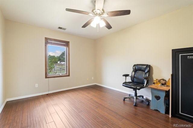 unfurnished office featuring ceiling fan and dark wood-type flooring