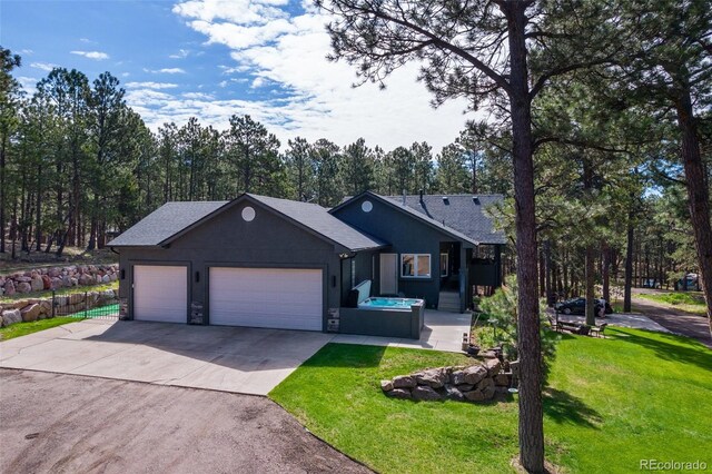 view of front of property featuring a front lawn and a garage