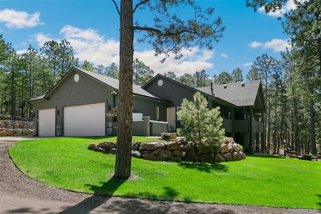 view of front facade with a front lawn and a garage