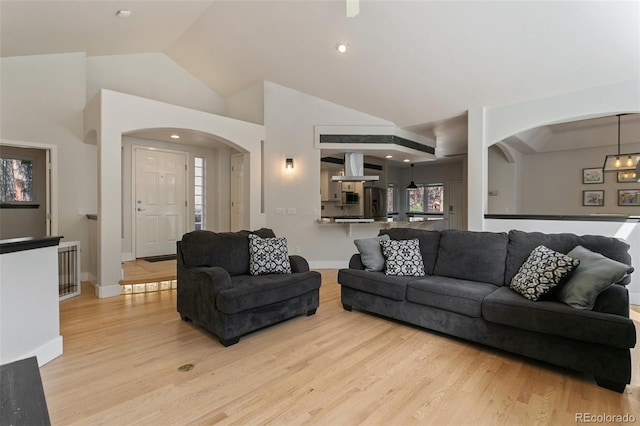 living room featuring light hardwood / wood-style flooring and lofted ceiling