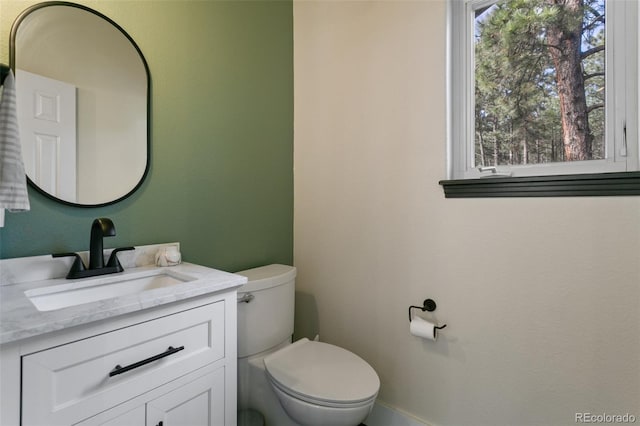 bathroom featuring vanity and toilet