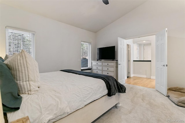 bedroom with vaulted ceiling, light carpet, and ceiling fan