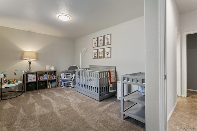 bedroom featuring carpet floors and a nursery area