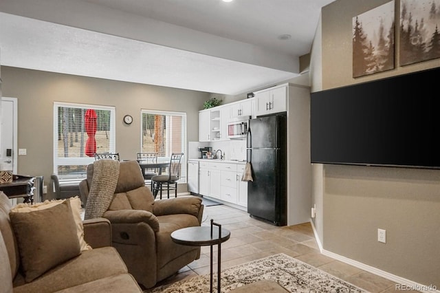 tiled living room featuring vaulted ceiling