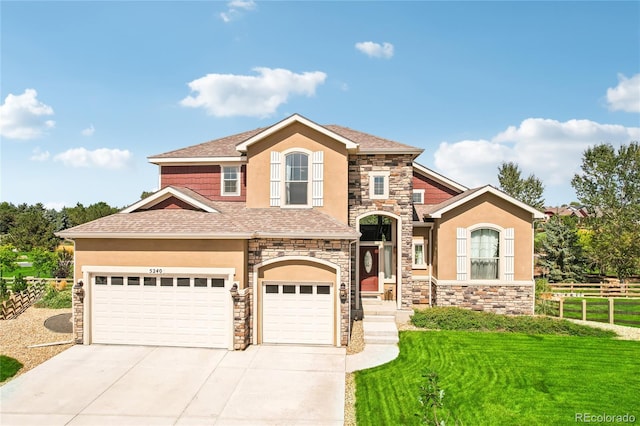 view of front of house featuring a front lawn and a garage