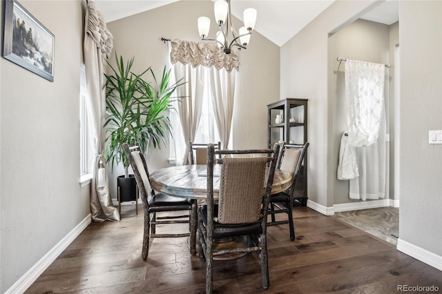 dining area featuring vaulted ceiling, dark hardwood / wood-style floors, and a chandelier