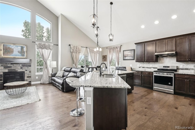 kitchen featuring a fireplace, dark hardwood / wood-style flooring, sink, and stainless steel stove