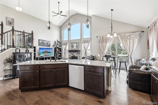 kitchen featuring dark wood-type flooring, ceiling fan with notable chandelier, dishwasher, and sink