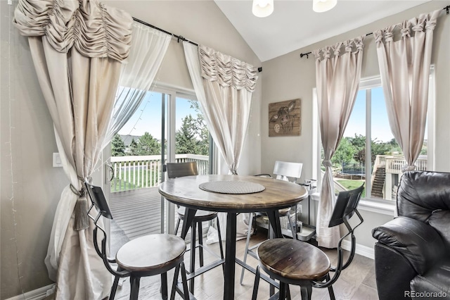 dining space featuring vaulted ceiling