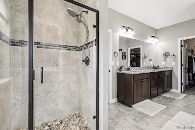 bathroom with vanity and a shower with door