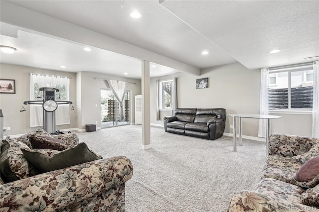 living room with a textured ceiling and carpet